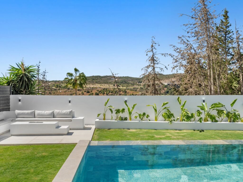 Outdoor lounge area beside the pool and garden