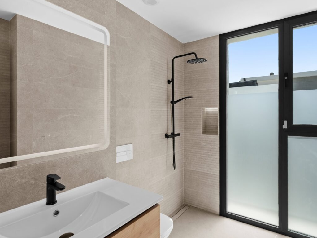 Bathroom with stone-effect tiles and walk-in rain shower