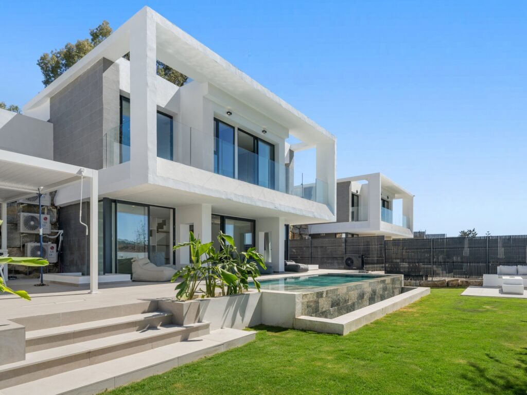 Contemporary white villa with lawn and pool in Estepona