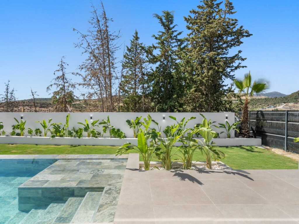 Private pool with sun ledge and tropical planting
