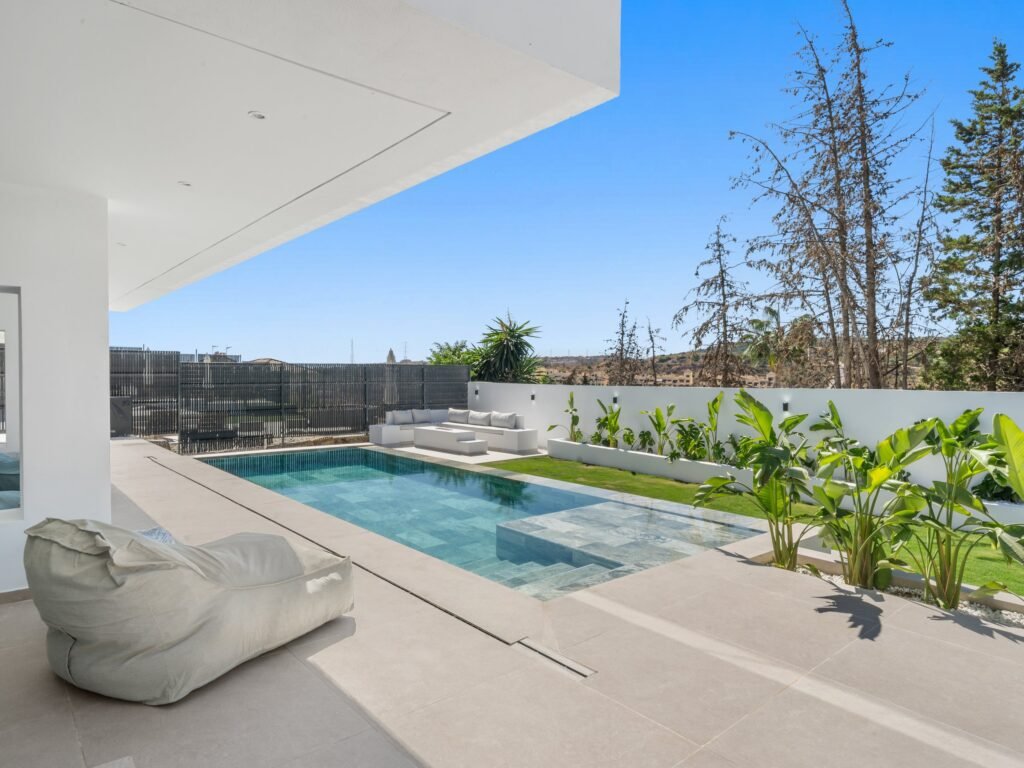 Covered porch overlooking the pool and garden