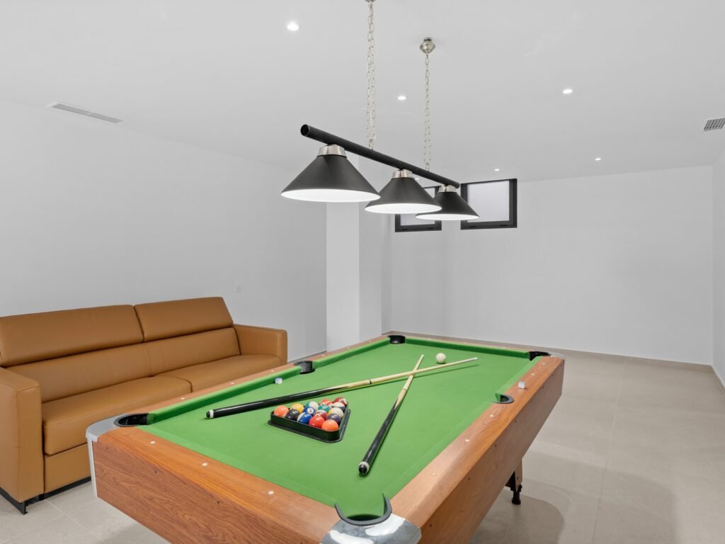 Games room with pool table and leather sofa